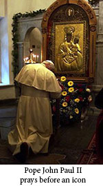 Pope John Paul II praying before an icon